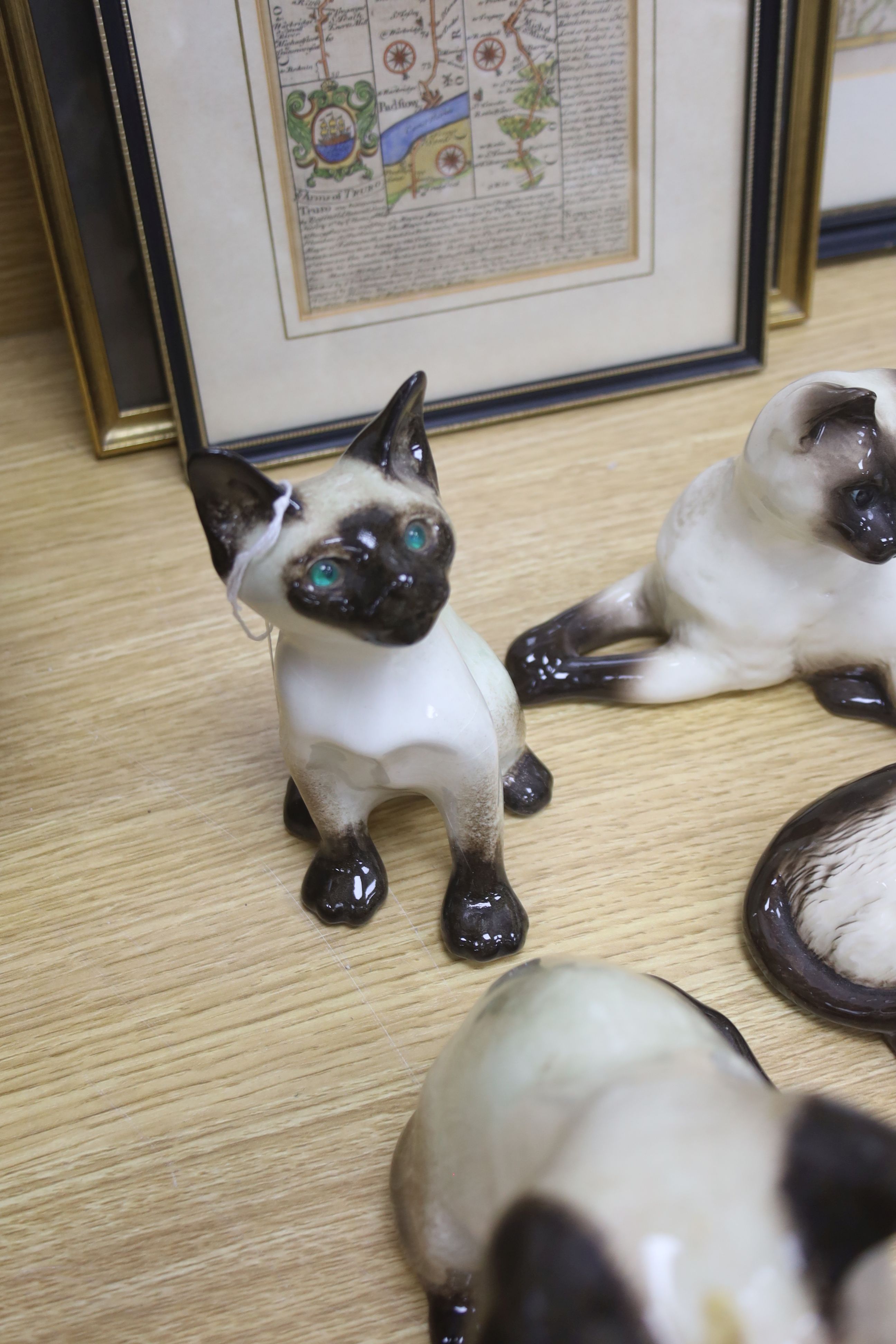 Twelve Beswick cats including Siamese